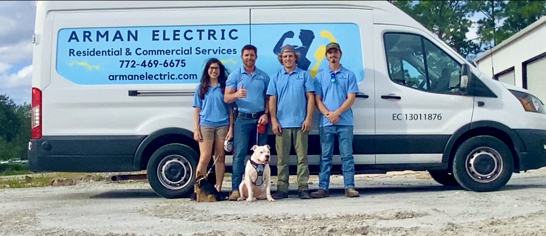 Arman Electric team standing beside the company van