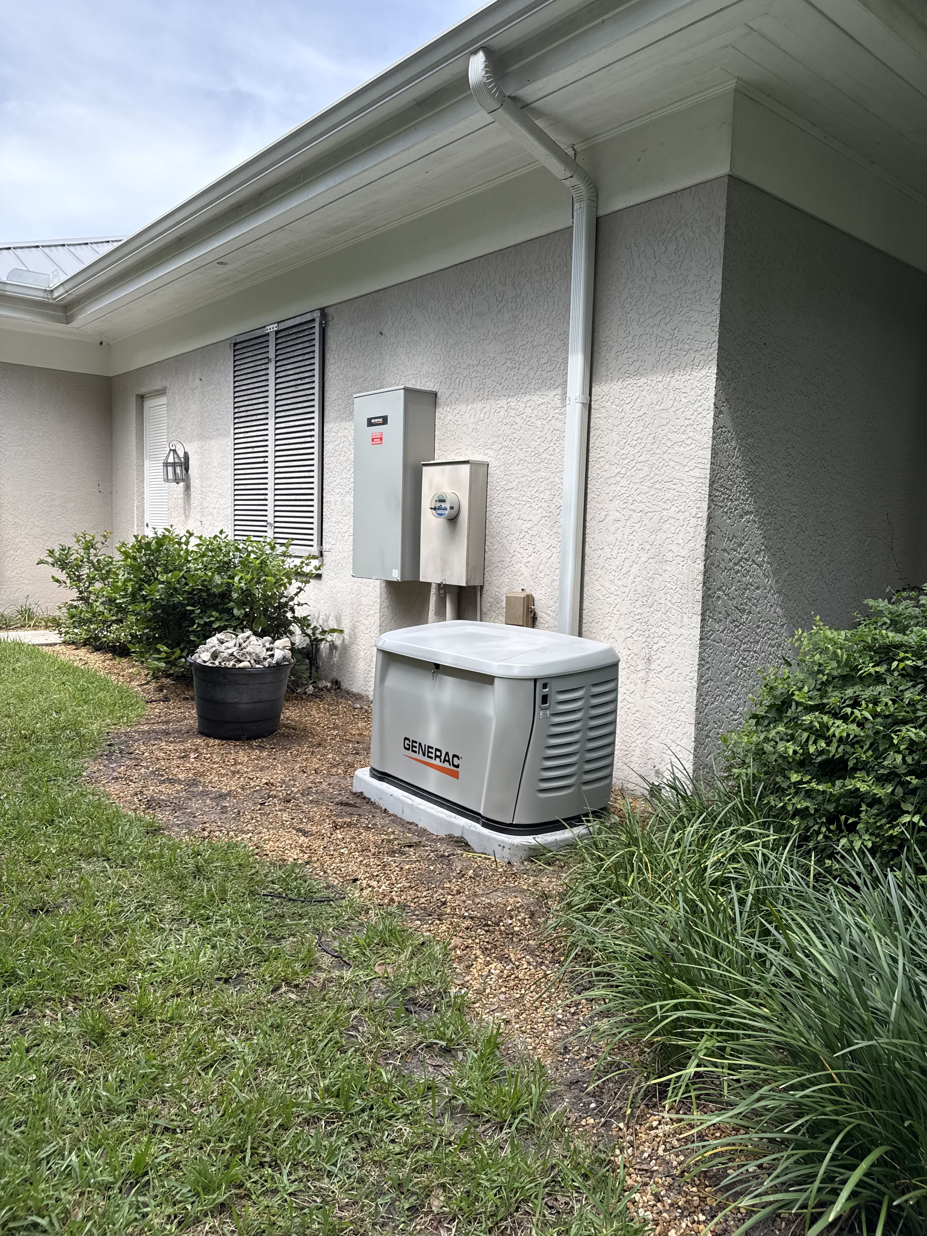 Generac generator installed beside a house