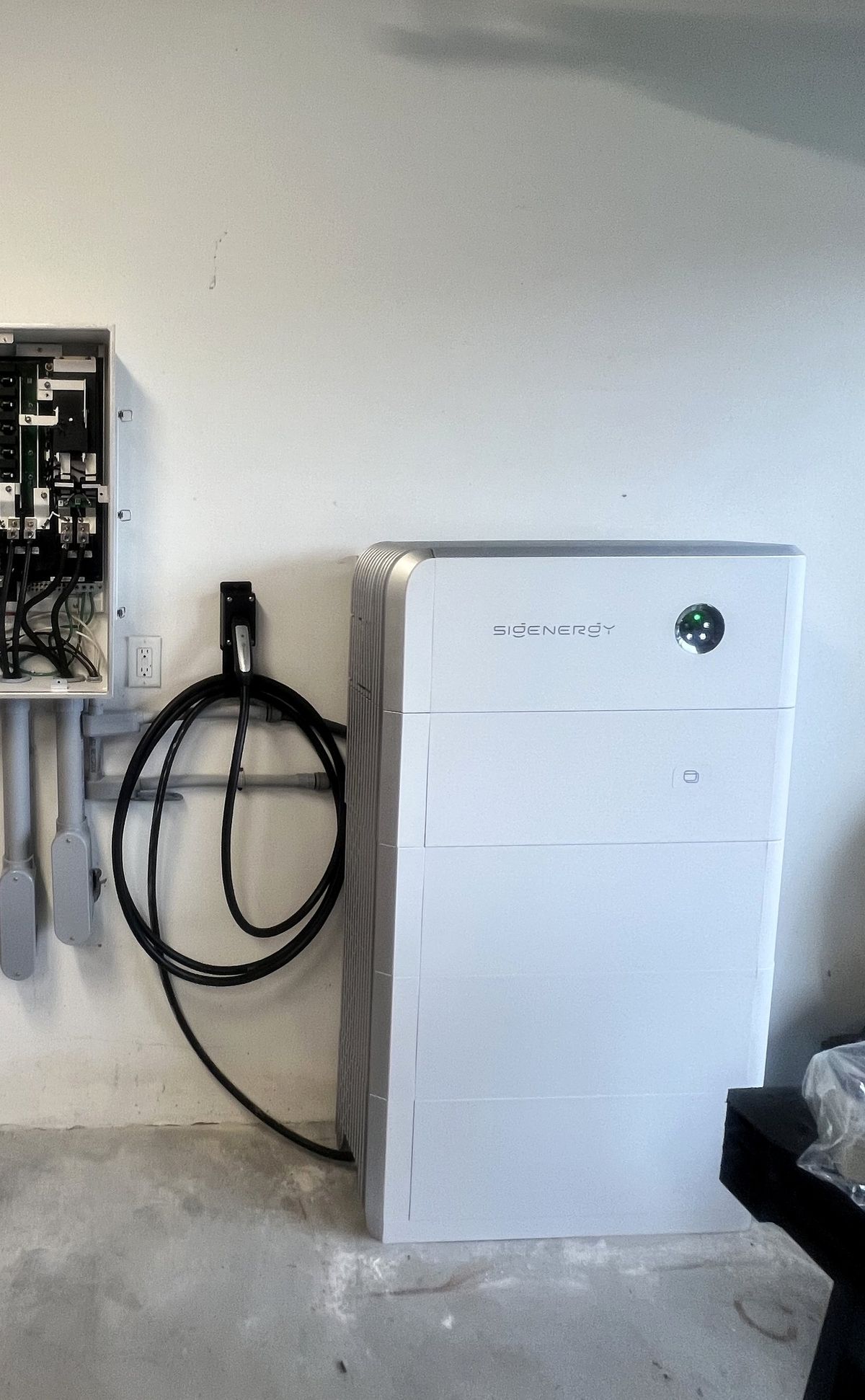 Close-up of a Sigenergy home battery mounted on a garage wall at a Vero Beach-area home